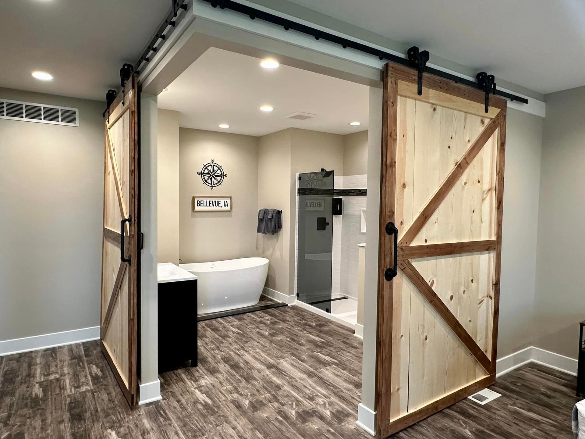 A bathroom with a bathtub and a sliding barn door.