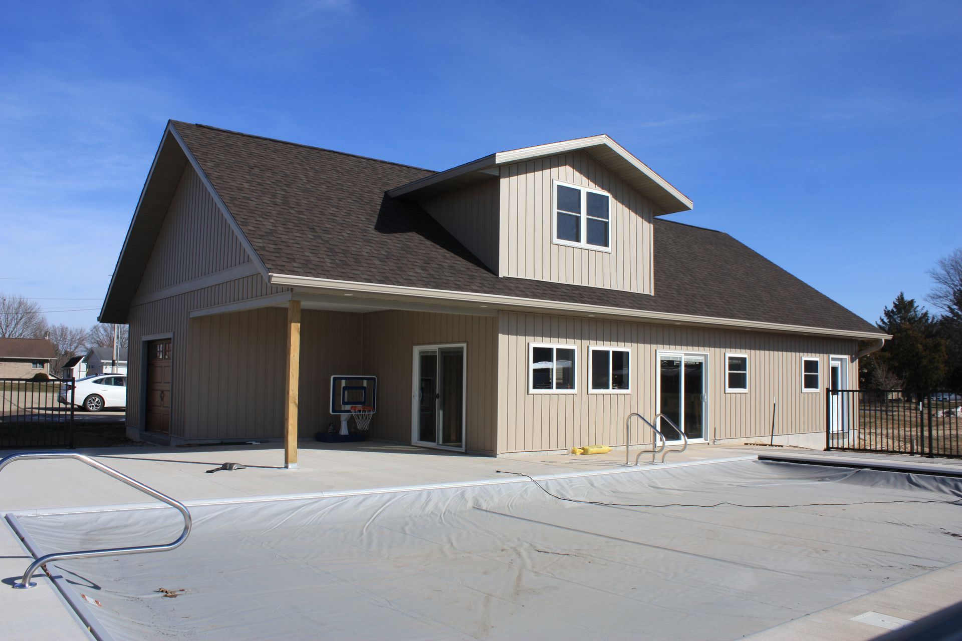 A large house with a brown roof and a lot of windows