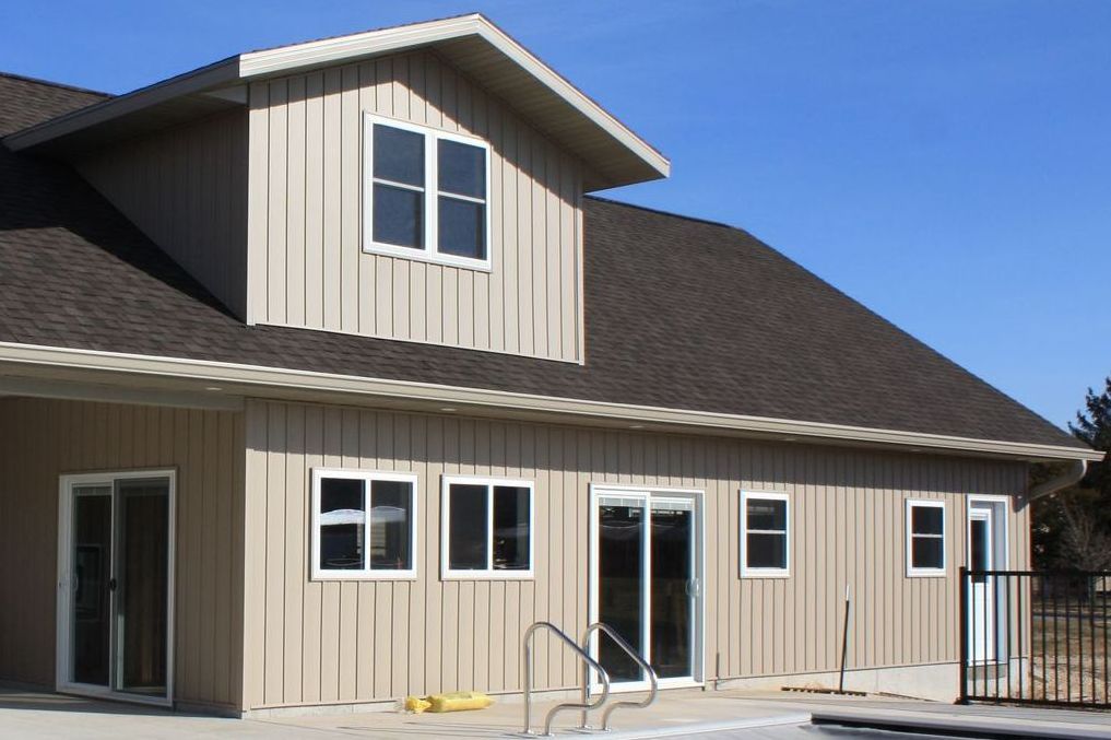 A house with a swimming pool in front of it
