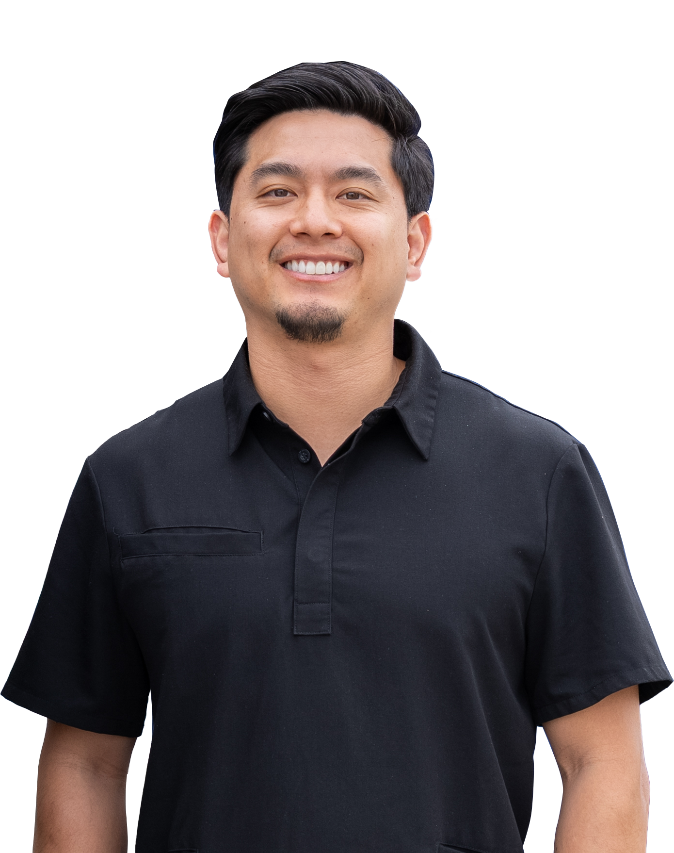 Man with dark hair and a black polo shirt smiles at the camera.