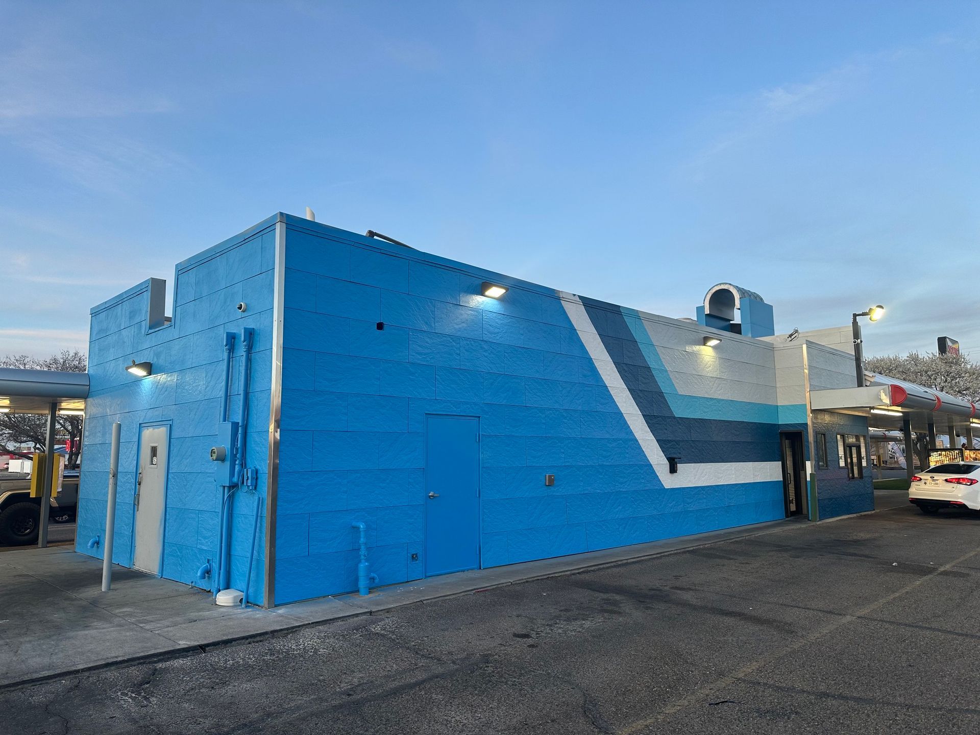 Blue building with angled white and blue stripes; exterior view.