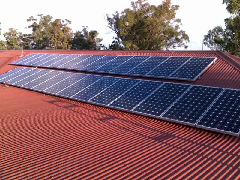 A Row of Solar Panels on A Red House Roof — Max Fox Electrical in Taminda, NSW