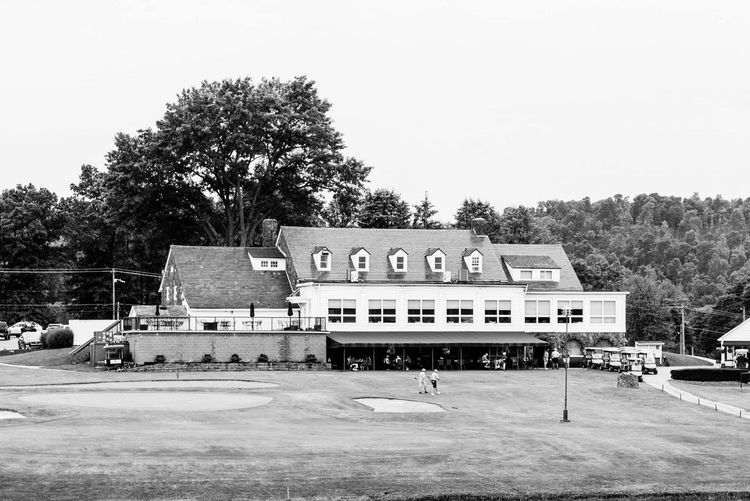 A black and white photo of a large building in the middle of a field