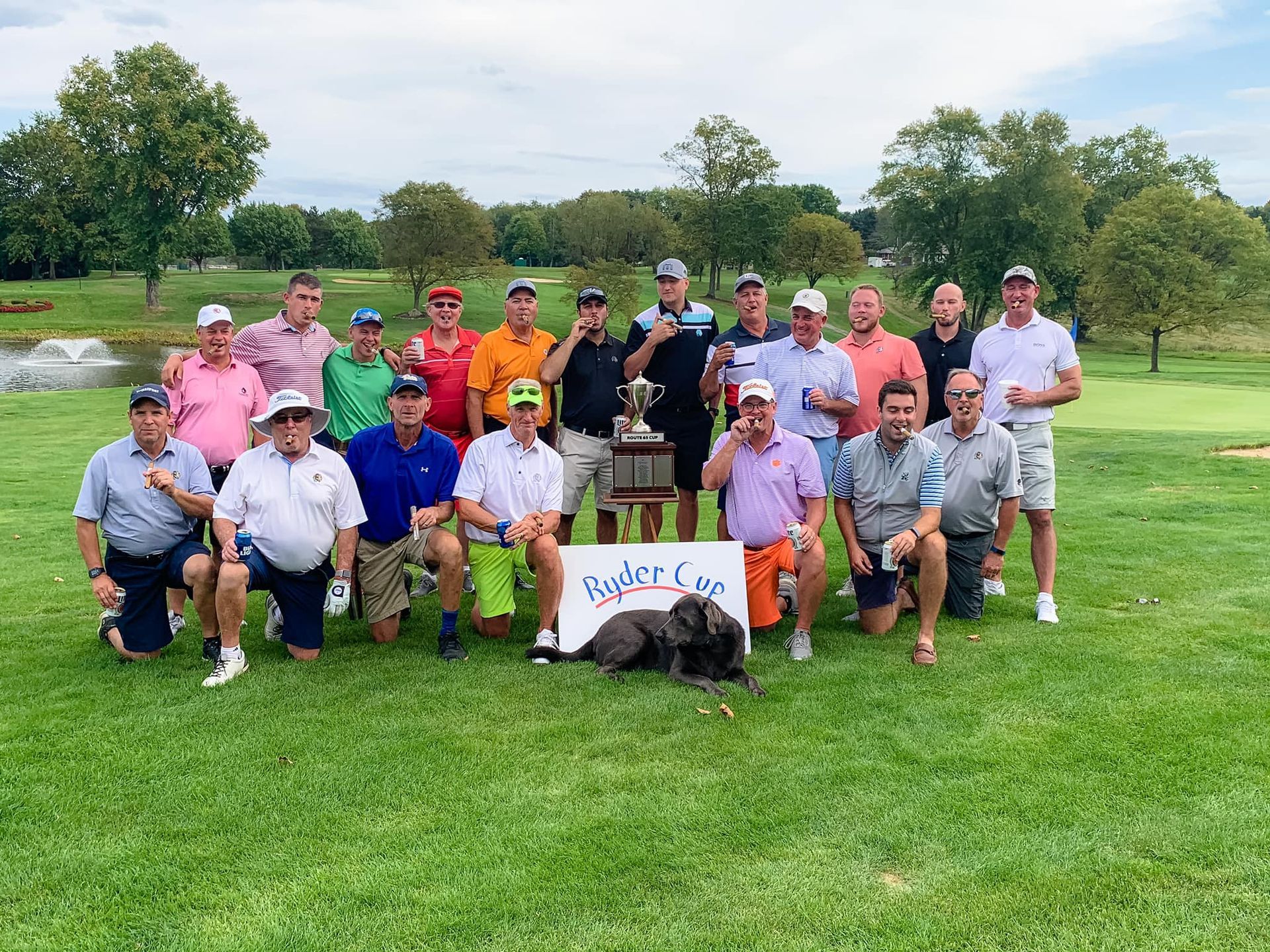 A group of men are posing for a picture on a golf course.