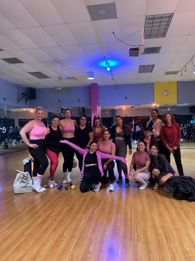 A group of women posing for a picture with one wearing a tank top that says i dont care