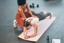 A group of women are posing for a picture in a gym.