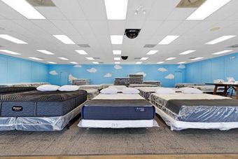 Two mattresses are sitting next to each other in a room.