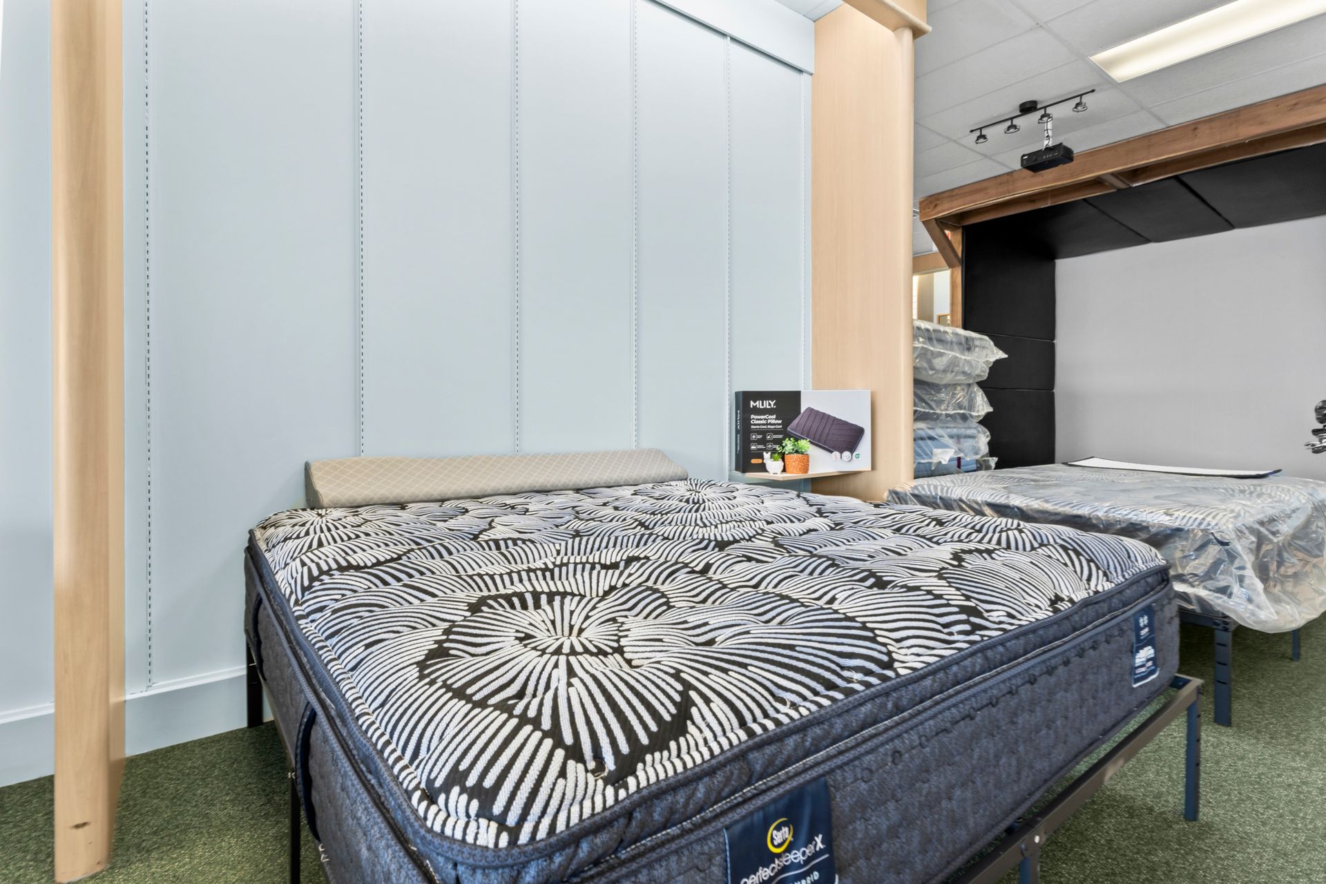 Two mattresses are sitting next to each other in a room. Two mattresses are sitting next to each other in a room.