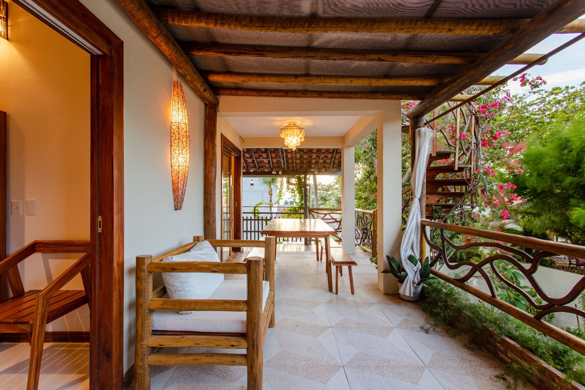 Há uma varanda com uma mesa e cadeiras.