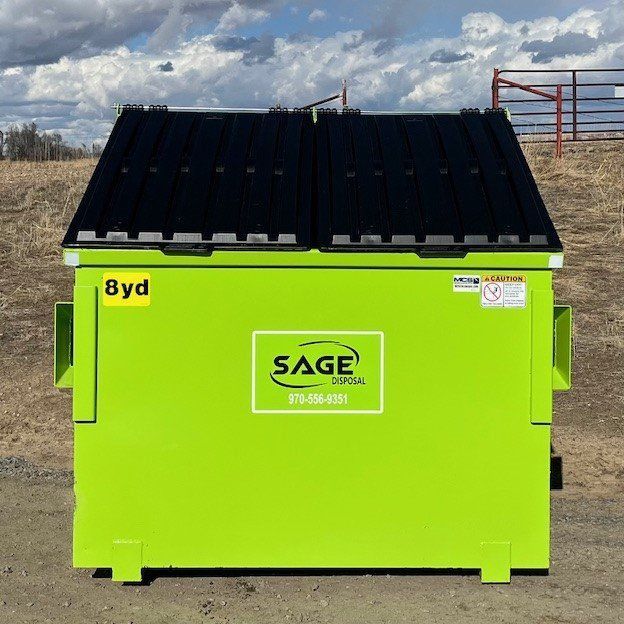 A green dumpster with the word sage on it