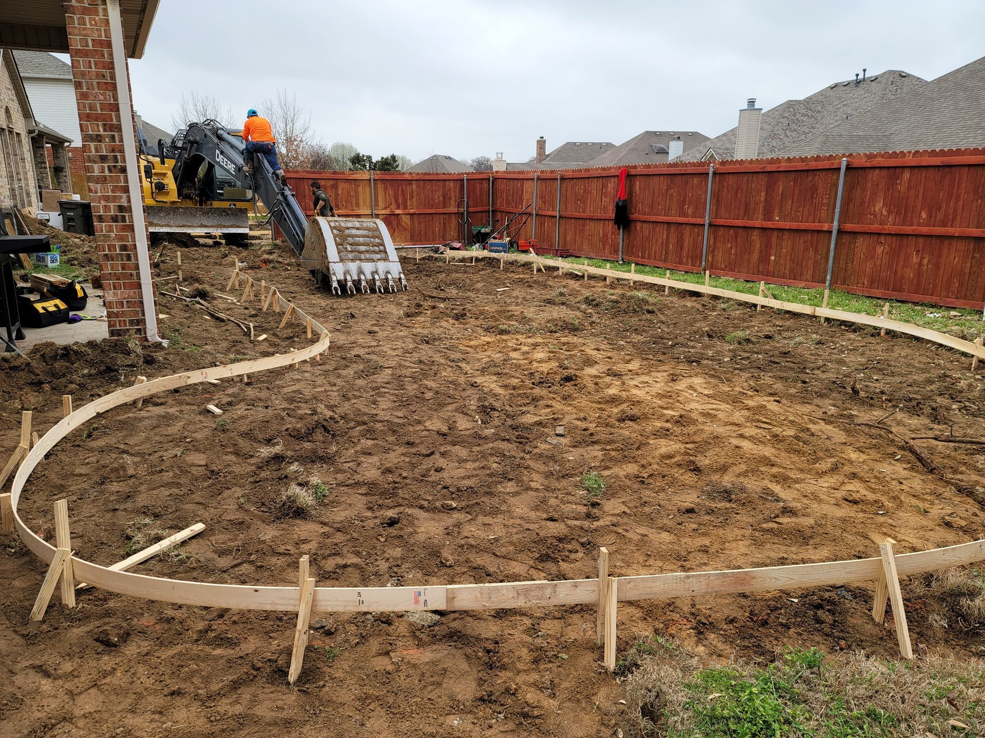A construction site with a fence and a bulldozer in the background.