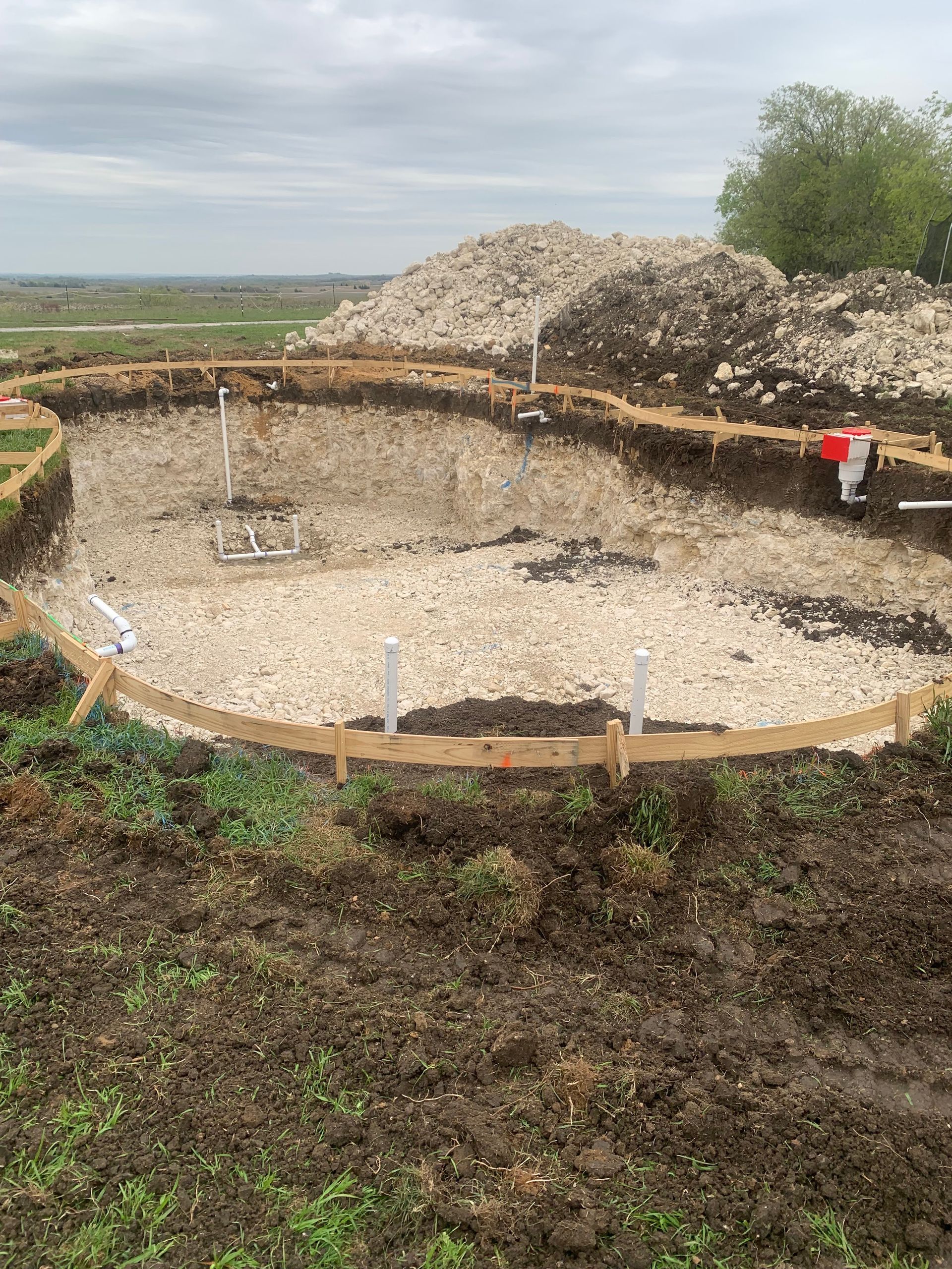 A large pile of dirt is sitting in the middle of a field.