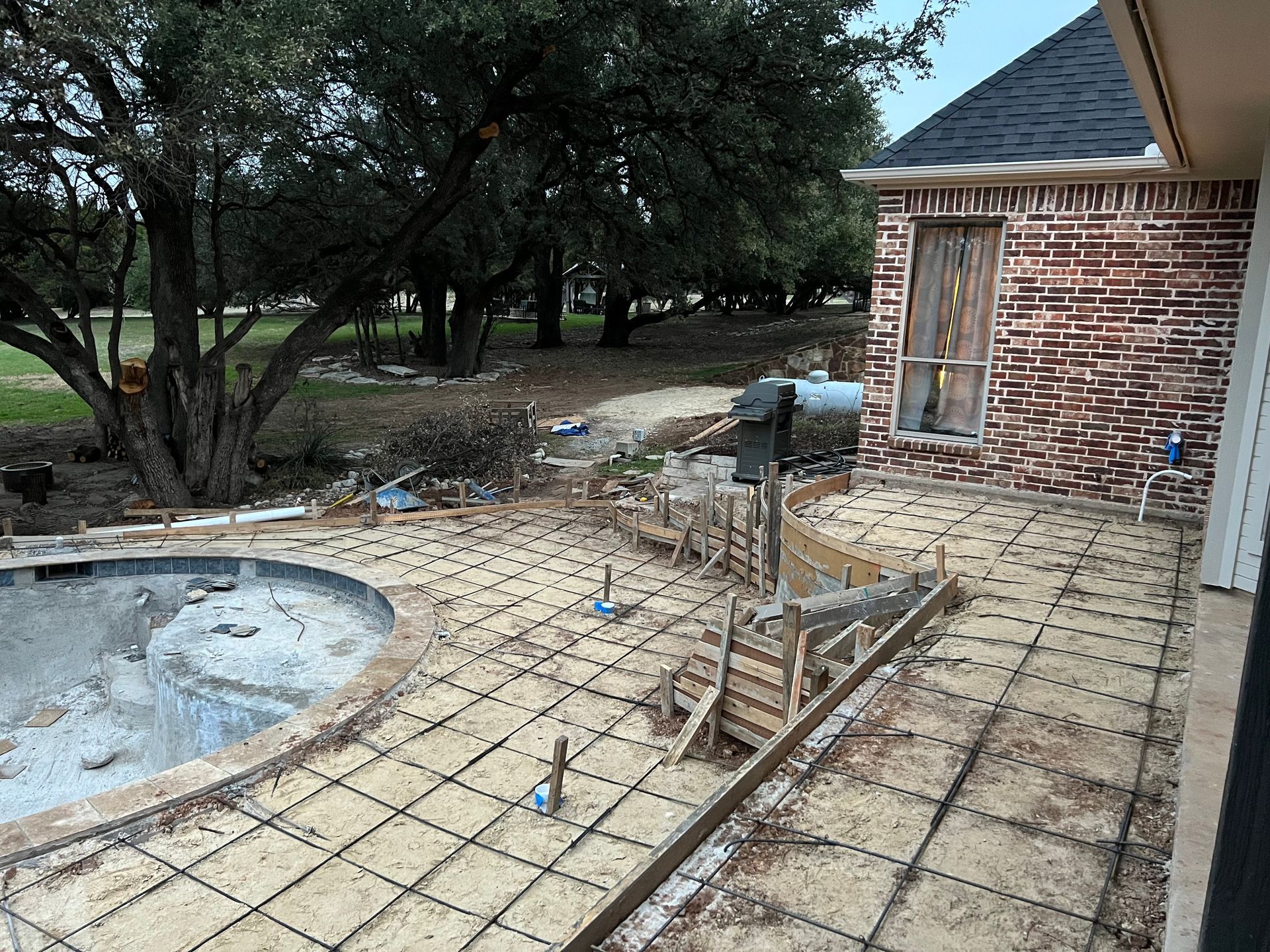 A brick house with a swimming pool under construction