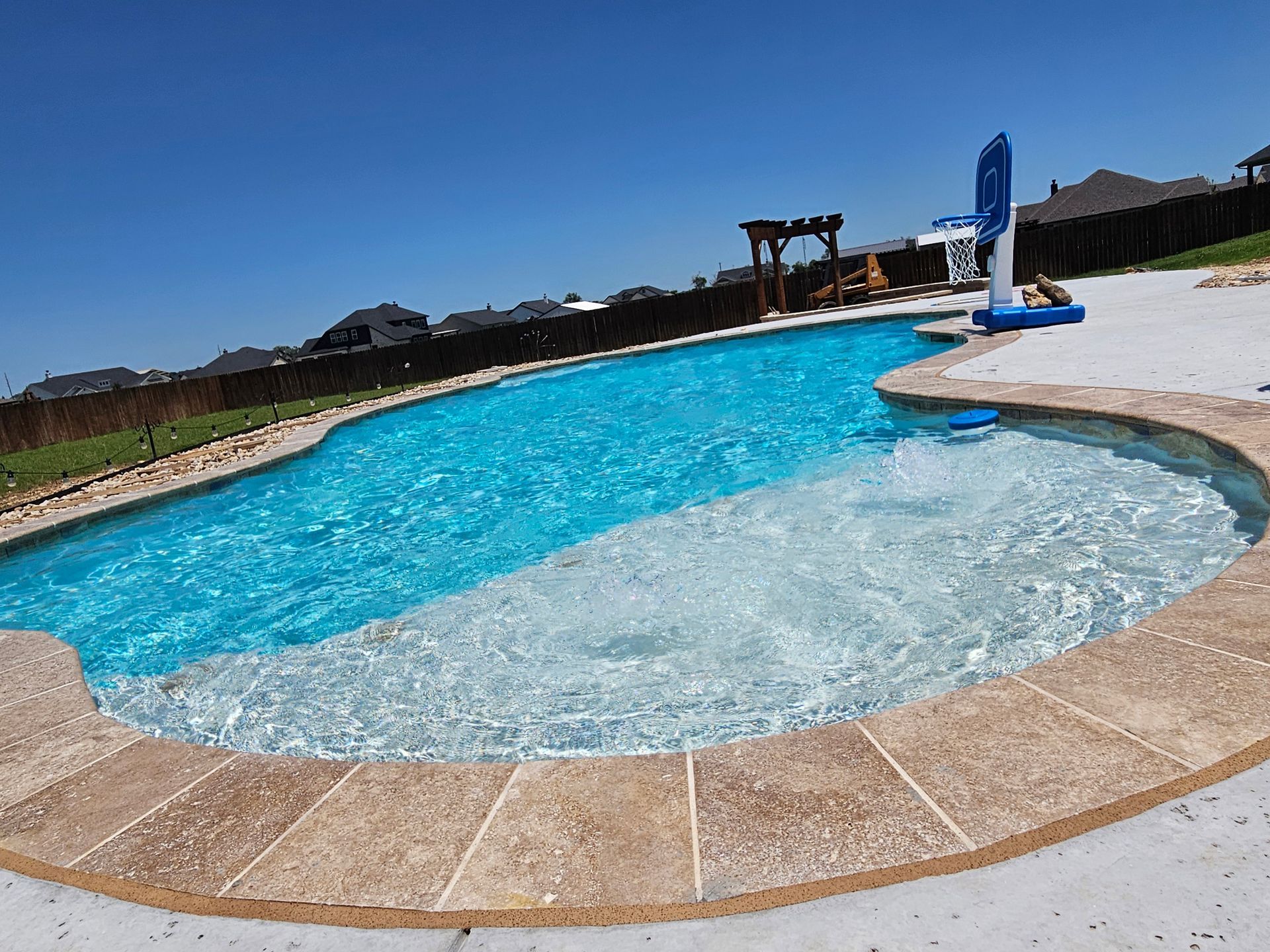 A person is working on a sand filter in a pool.