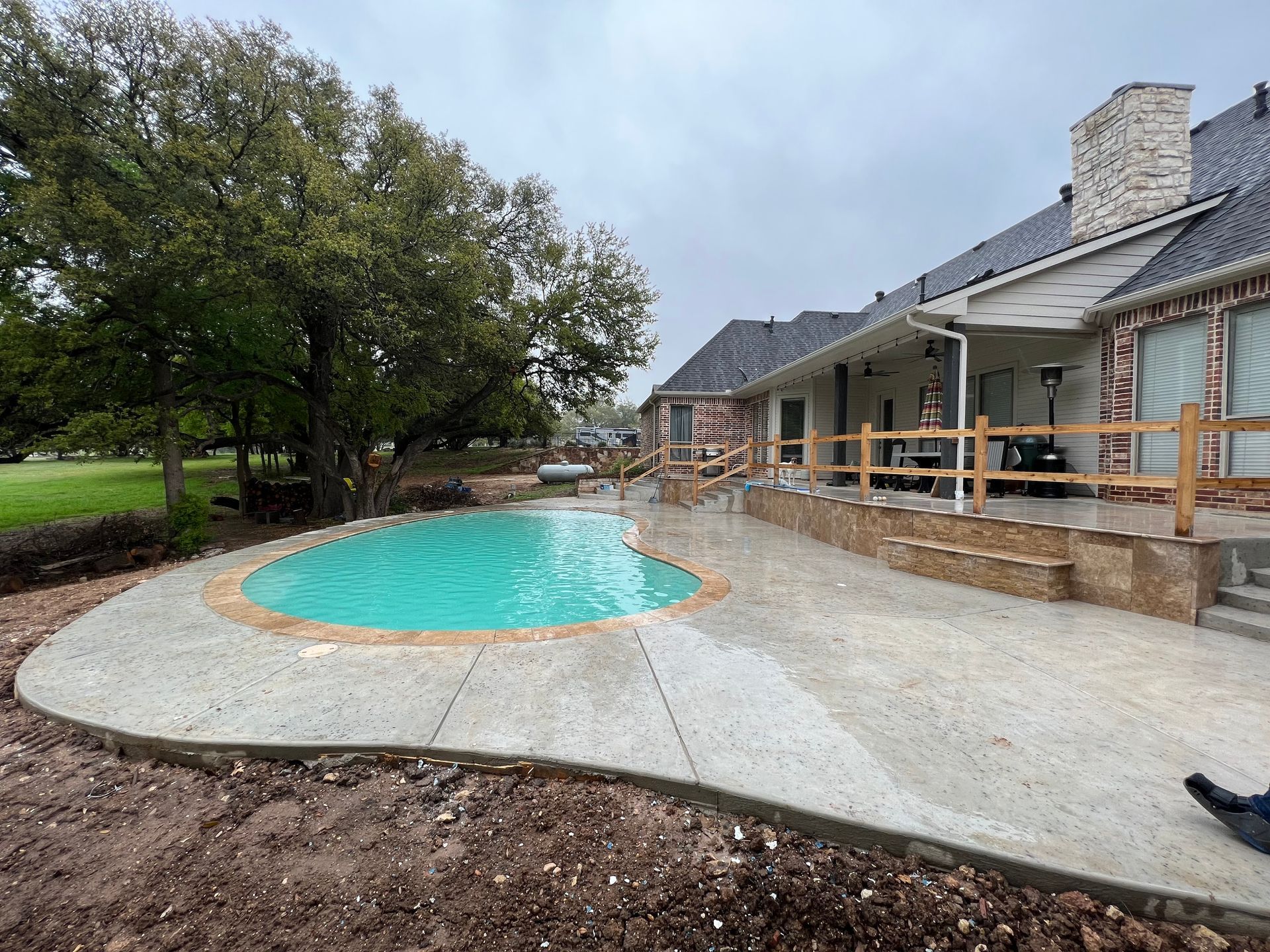 A large house with a swimming pool in front of it