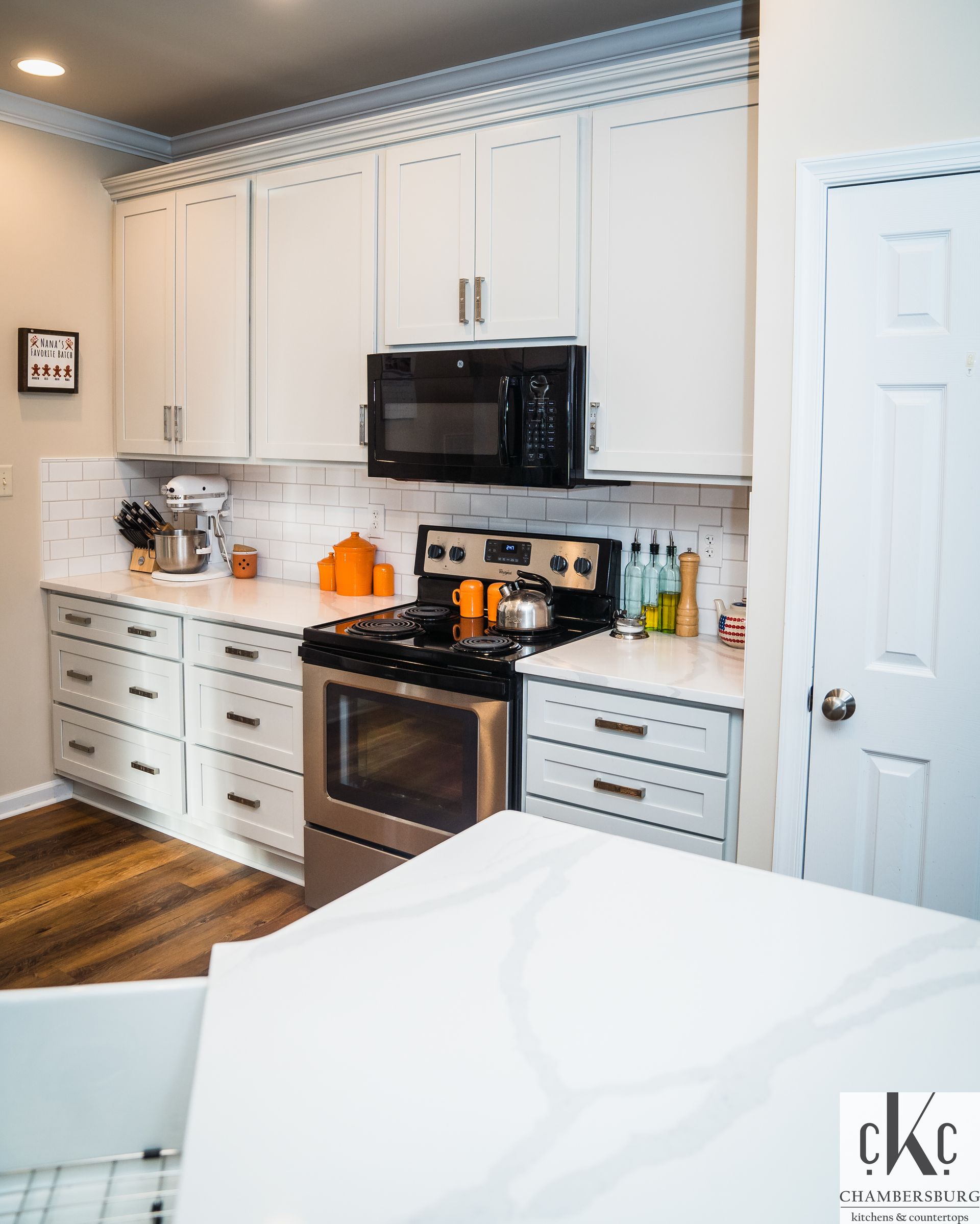 A kitchen with white cabinets and stainless steel appliances