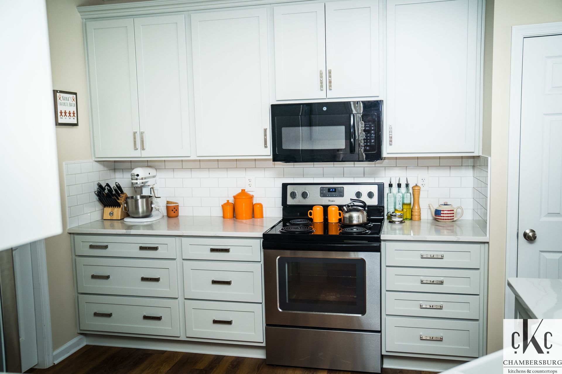 A kitchen with white cabinets and stainless steel appliances