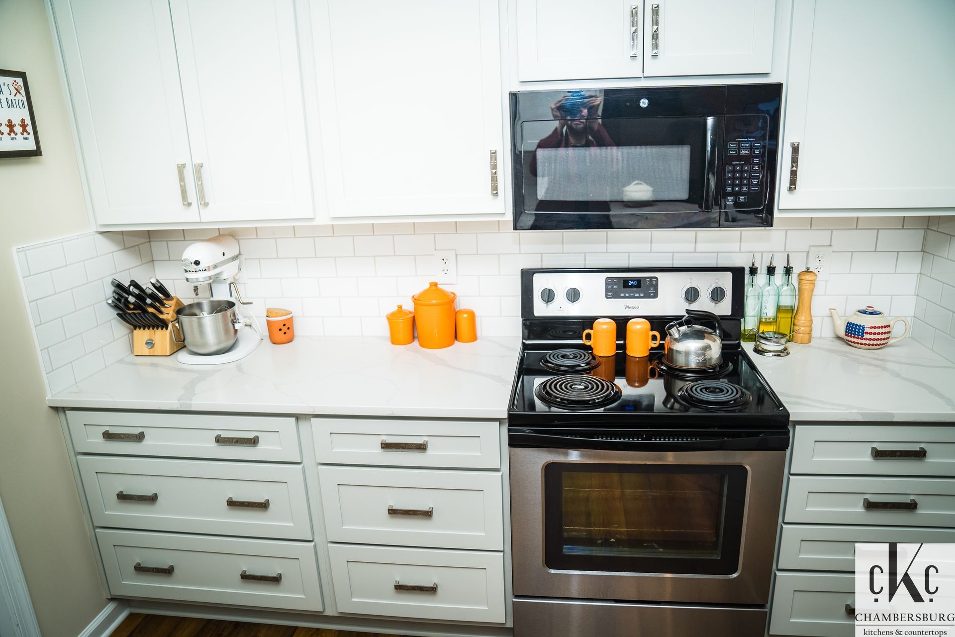 A kitchen with white cabinets and stainless steel appliances