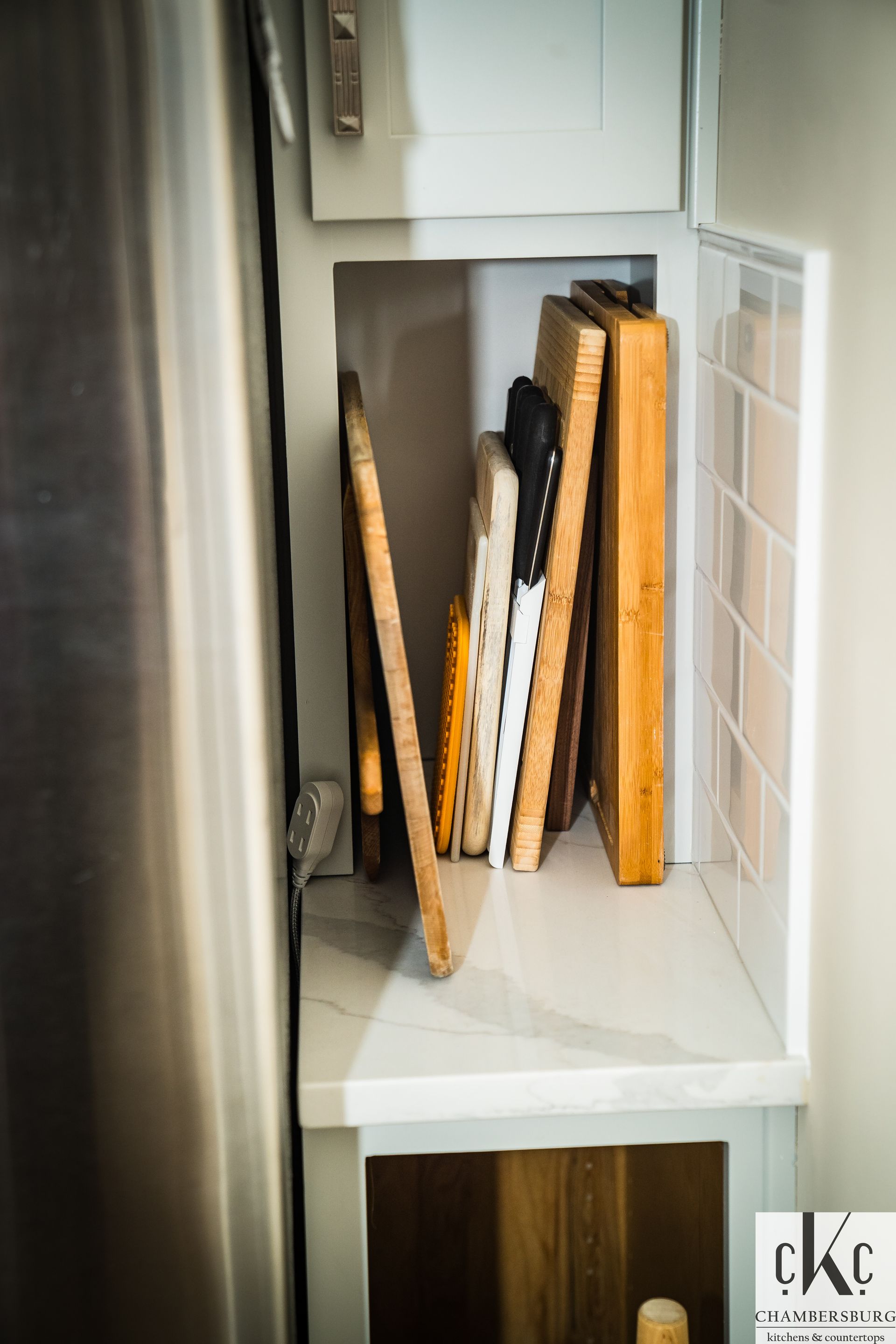 A shelf with cutting boards and knives on it