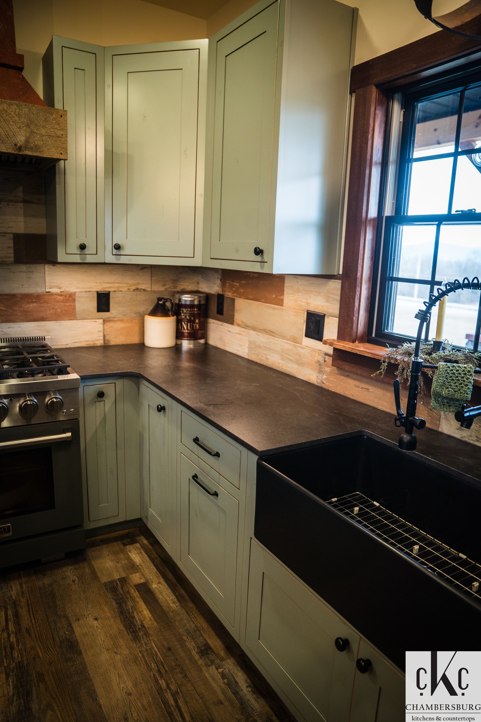 A kitchen with blue cabinets and a black sink