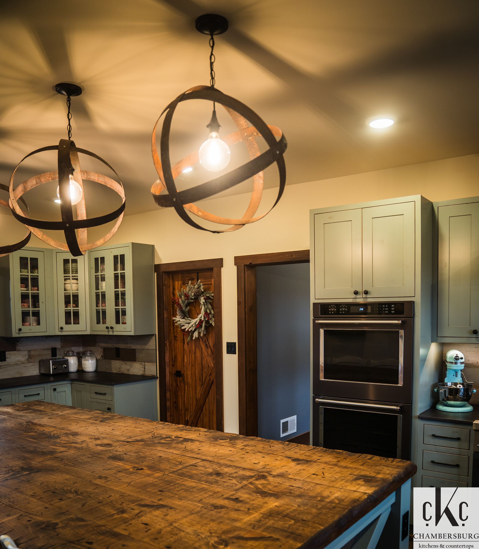 A kitchen with a wooden table and a sign that says ckc
