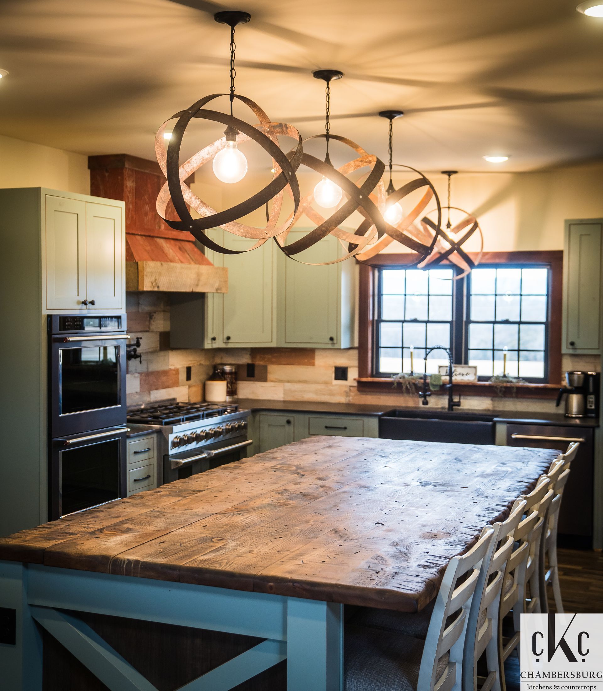 A kitchen with a large wooden table and chairs