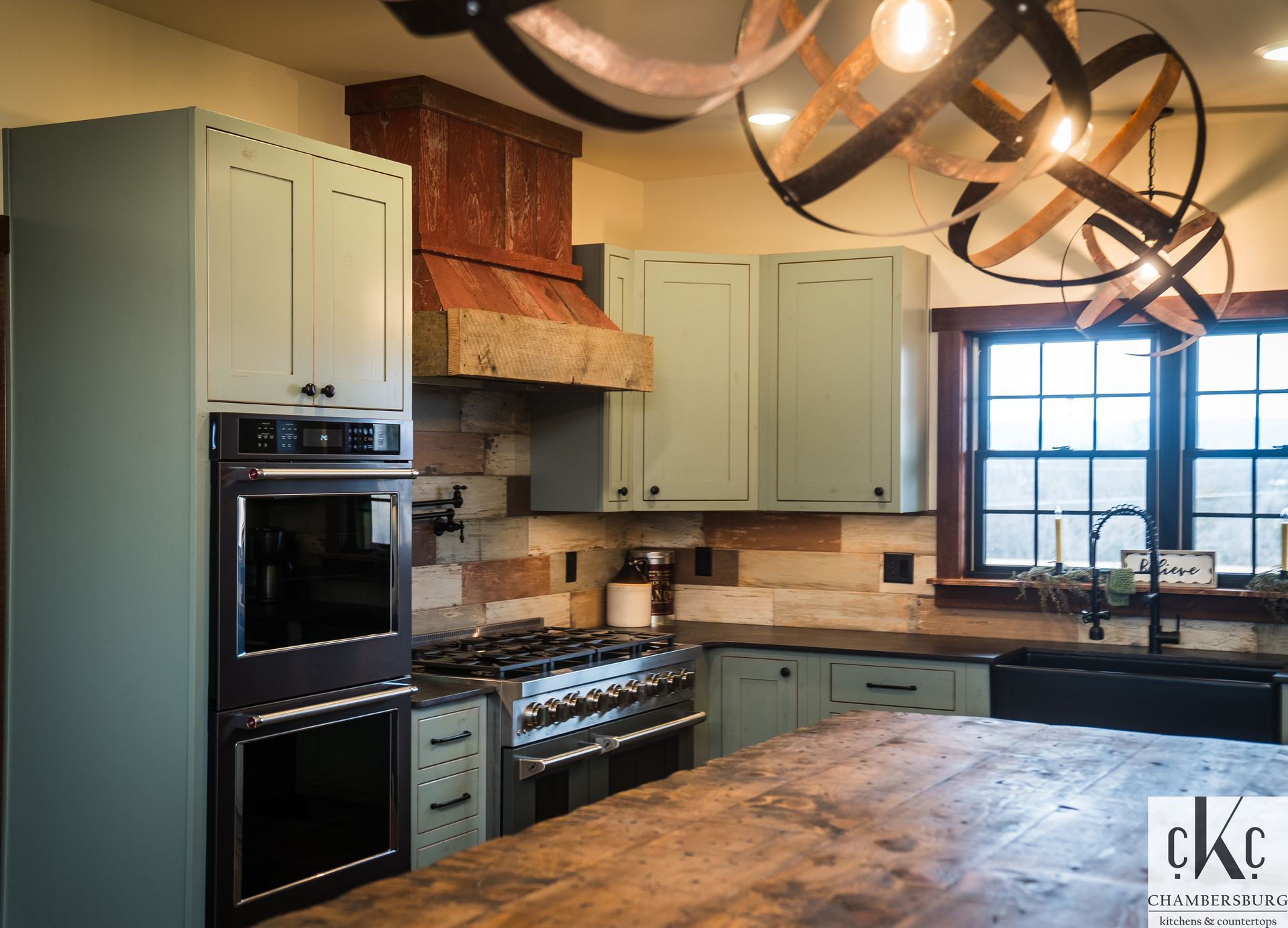 A kitchen with a stove, oven, refrigerator and sink.