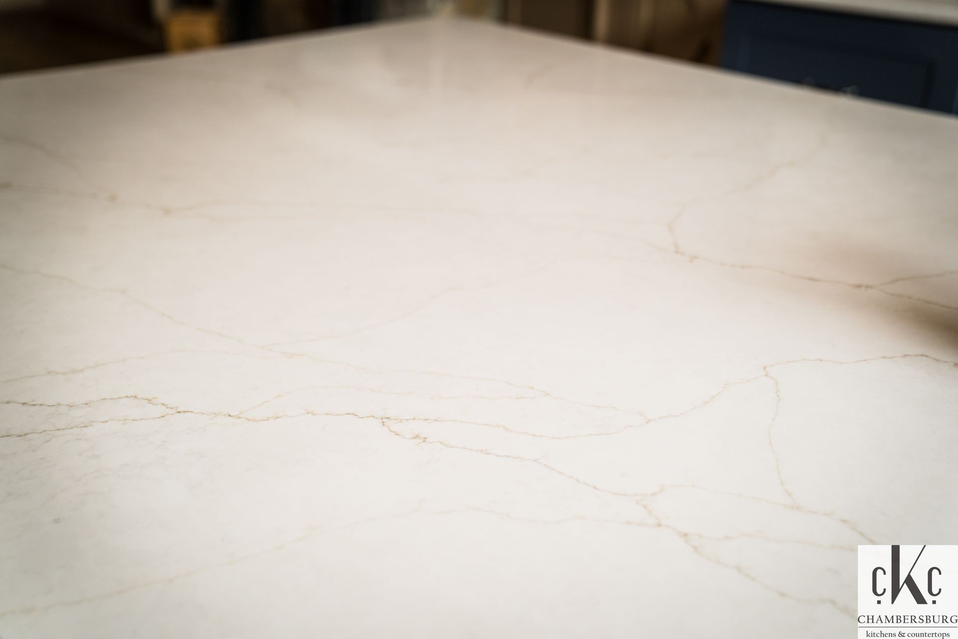 A close up of a white marble counter top in a kitchen.