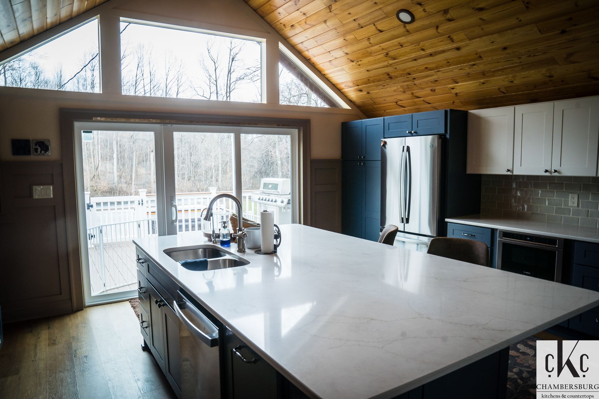 A kitchen with a large island in the middle and a large window.