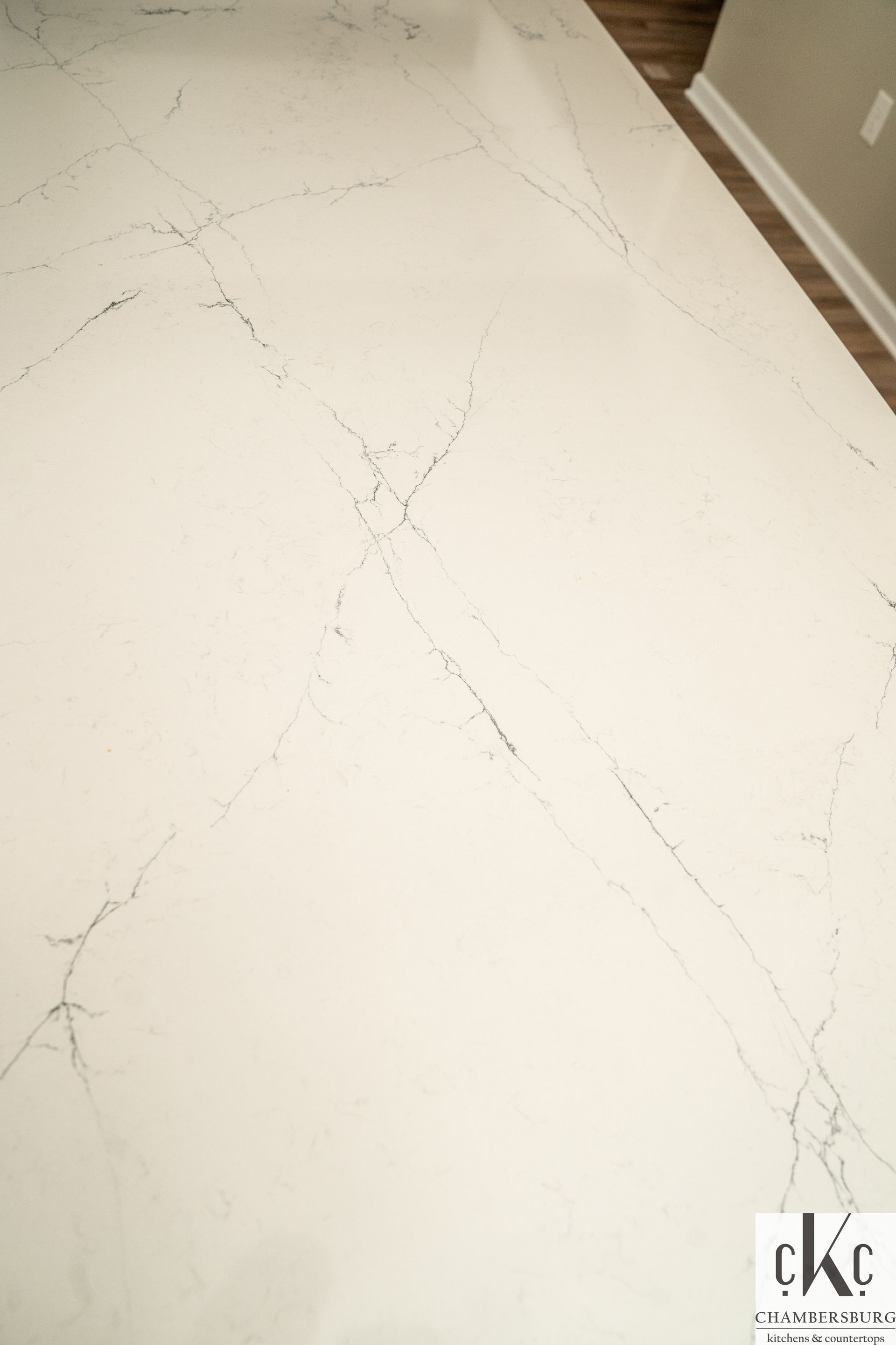 A close up of a white marble counter top in a kitchen.