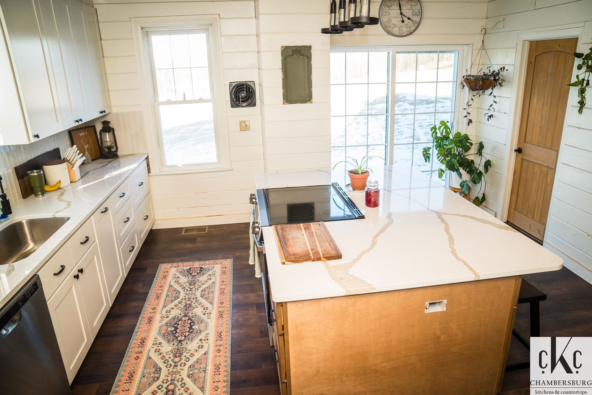 A kitchen with a large island in the middle of it.