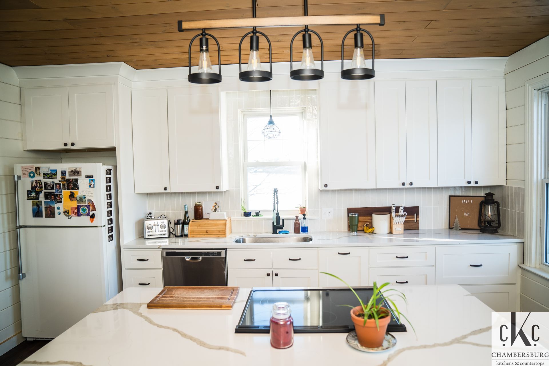 A man and a woman are looking at a blueprint in a kitchen, Mont Alto, PA, Downin Building & Remodeling.
