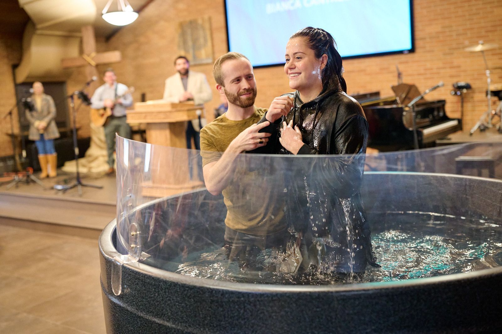 A woman is being baptized in a church.