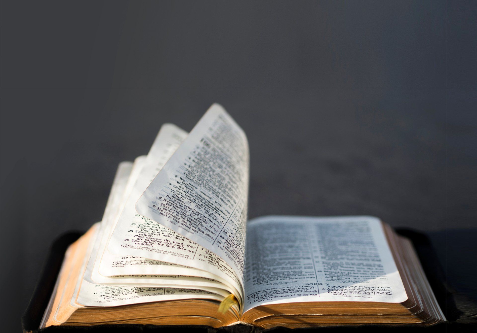 A close up of an open bible on a table.