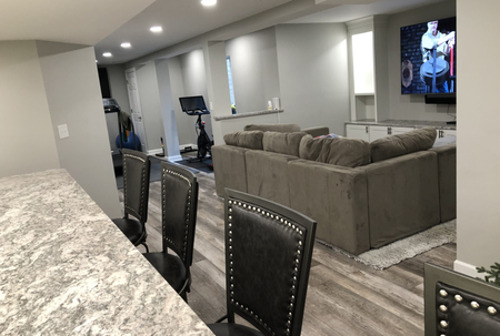 finished basement with a living space and gym area