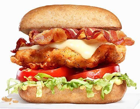 A pepperoni pizza with a slice taken out of it on a white background.