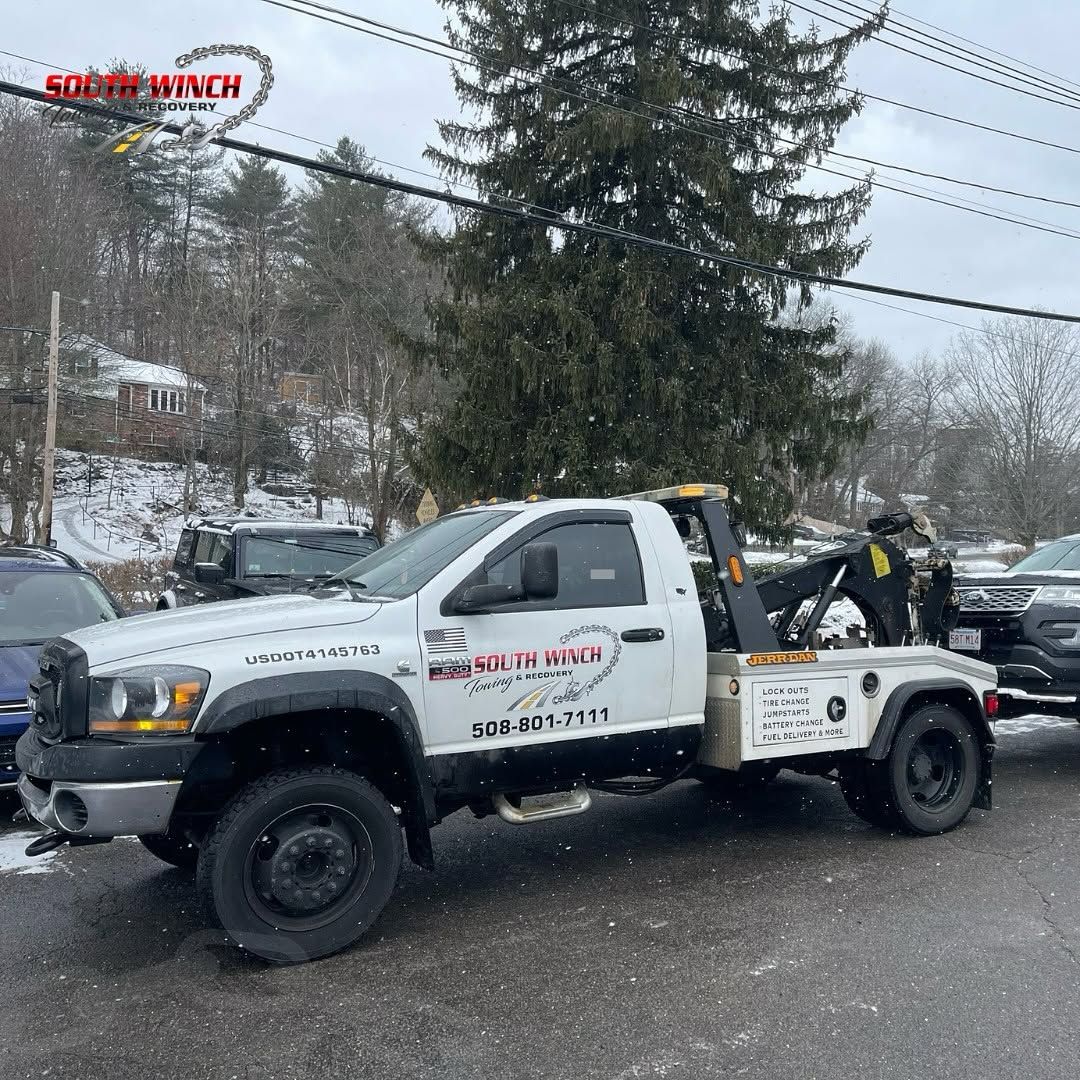 A tow truck is parked on the side of the road.