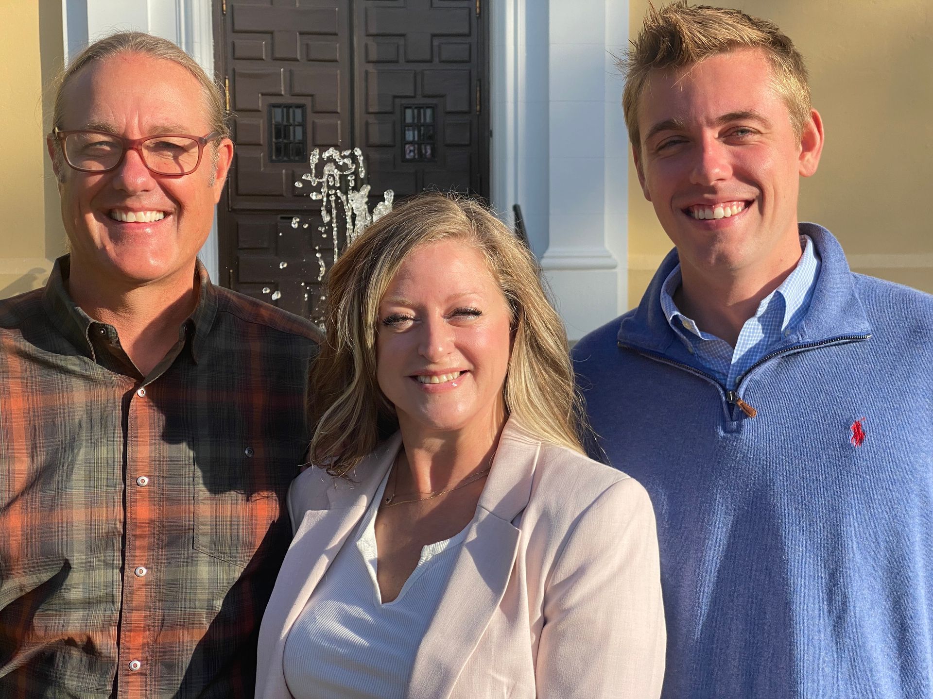 A man and a woman are holding hands on a wooden table.