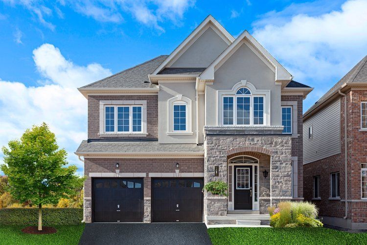 A large house with two garages and a tree in front of it