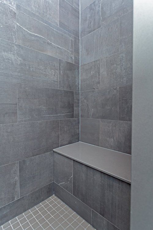 There is a bench in the corner of the shower.