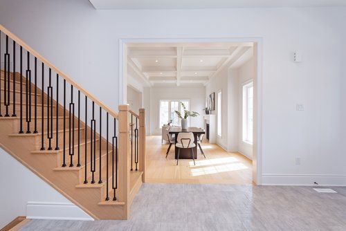 A wooden staircase leading up to a dining room in a house.