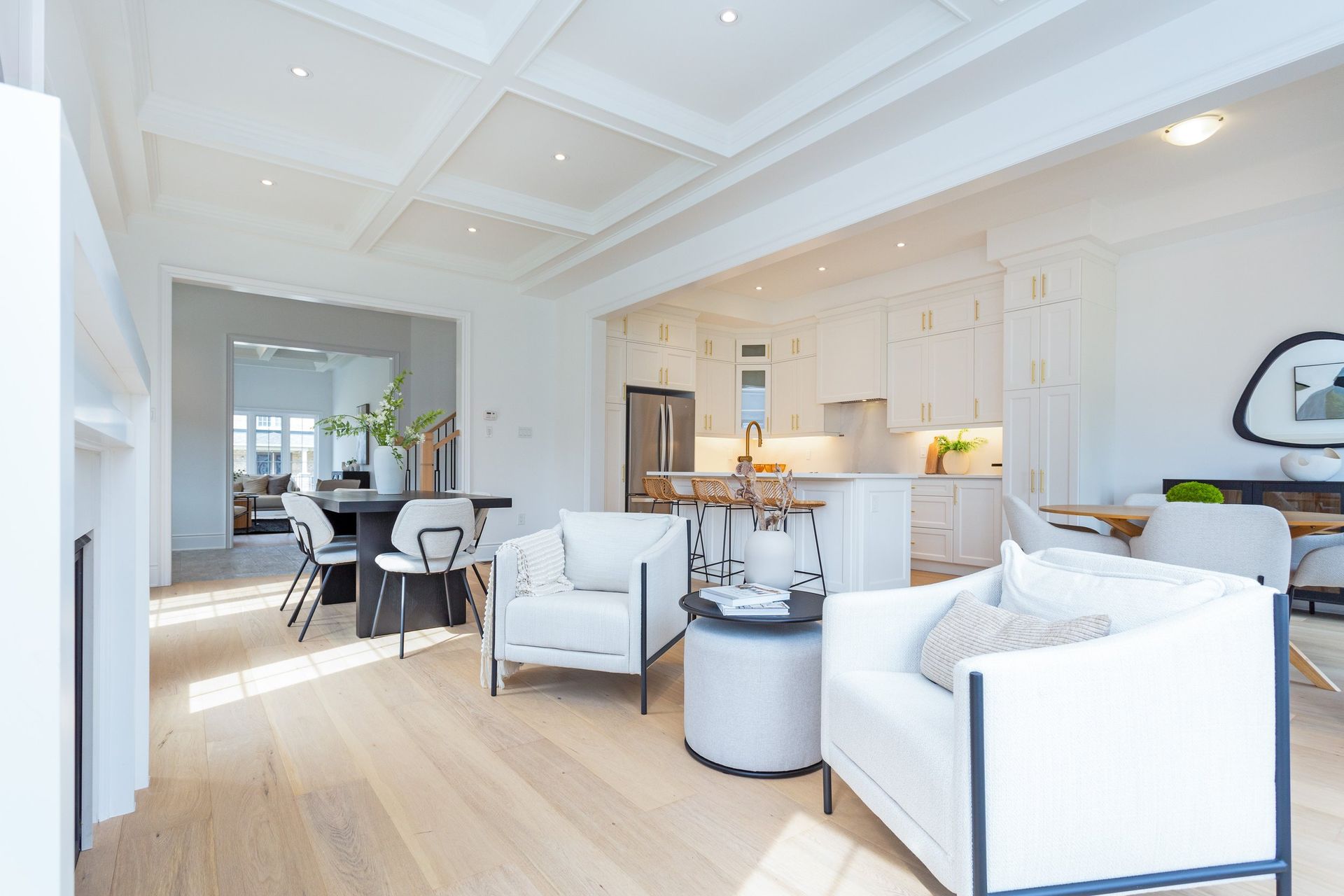 A living room filled with furniture and a kitchen in a house.