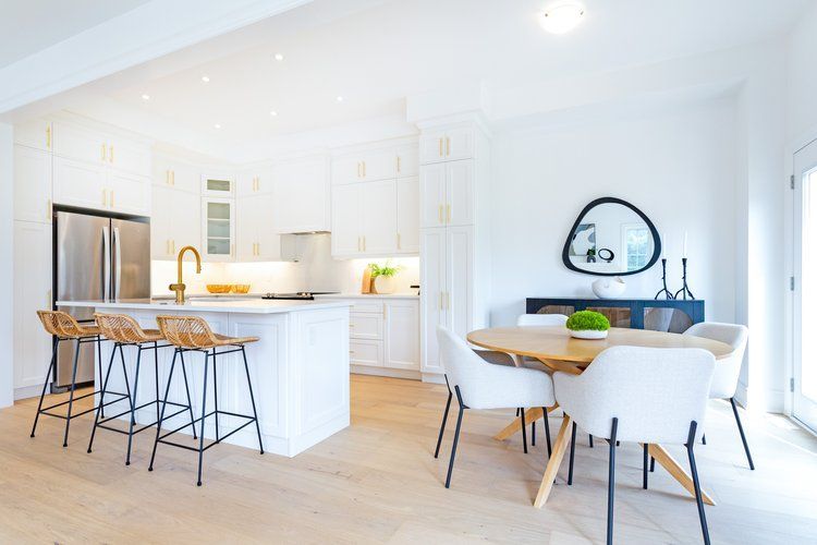 A kitchen and dining room in a house with a table and chairs.