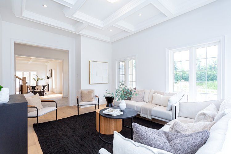 A living room with a couch , chairs , and a coffee table.