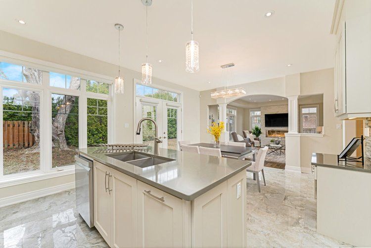 A kitchen in a house with a large island and a sink.