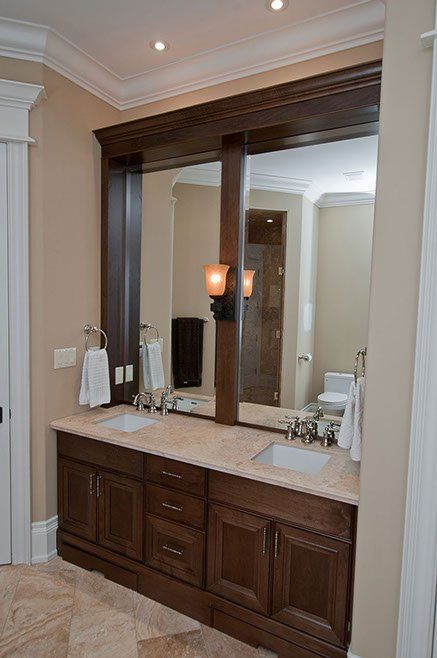 A bathroom with two sinks and a large mirror.
