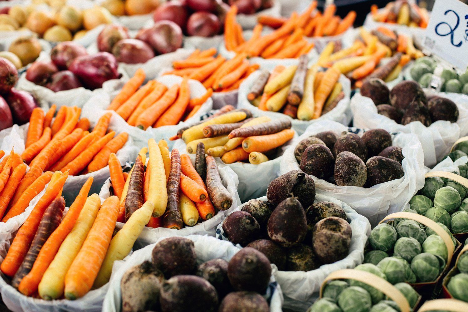 A variety of fruits and vegetables are on display at a farmers market.