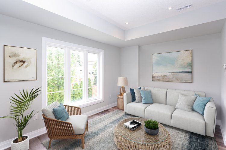 A living room with a couch , chair , and coffee table.