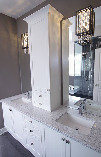 A bathroom with two sinks and a large mirror