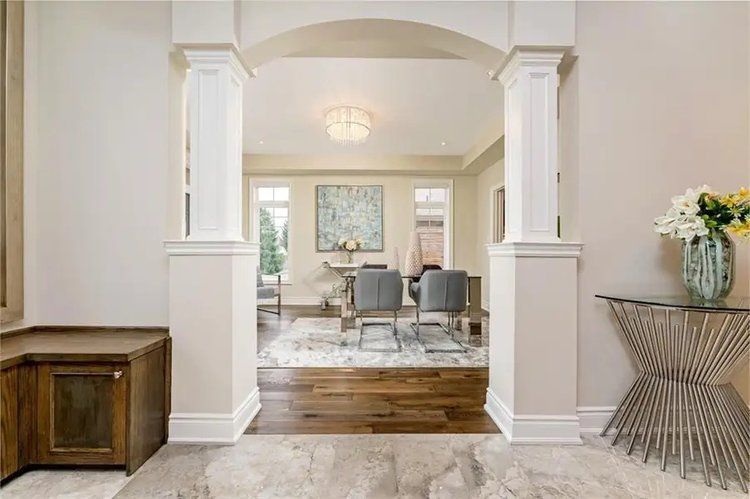 A view of a living room from a hallway in a house.